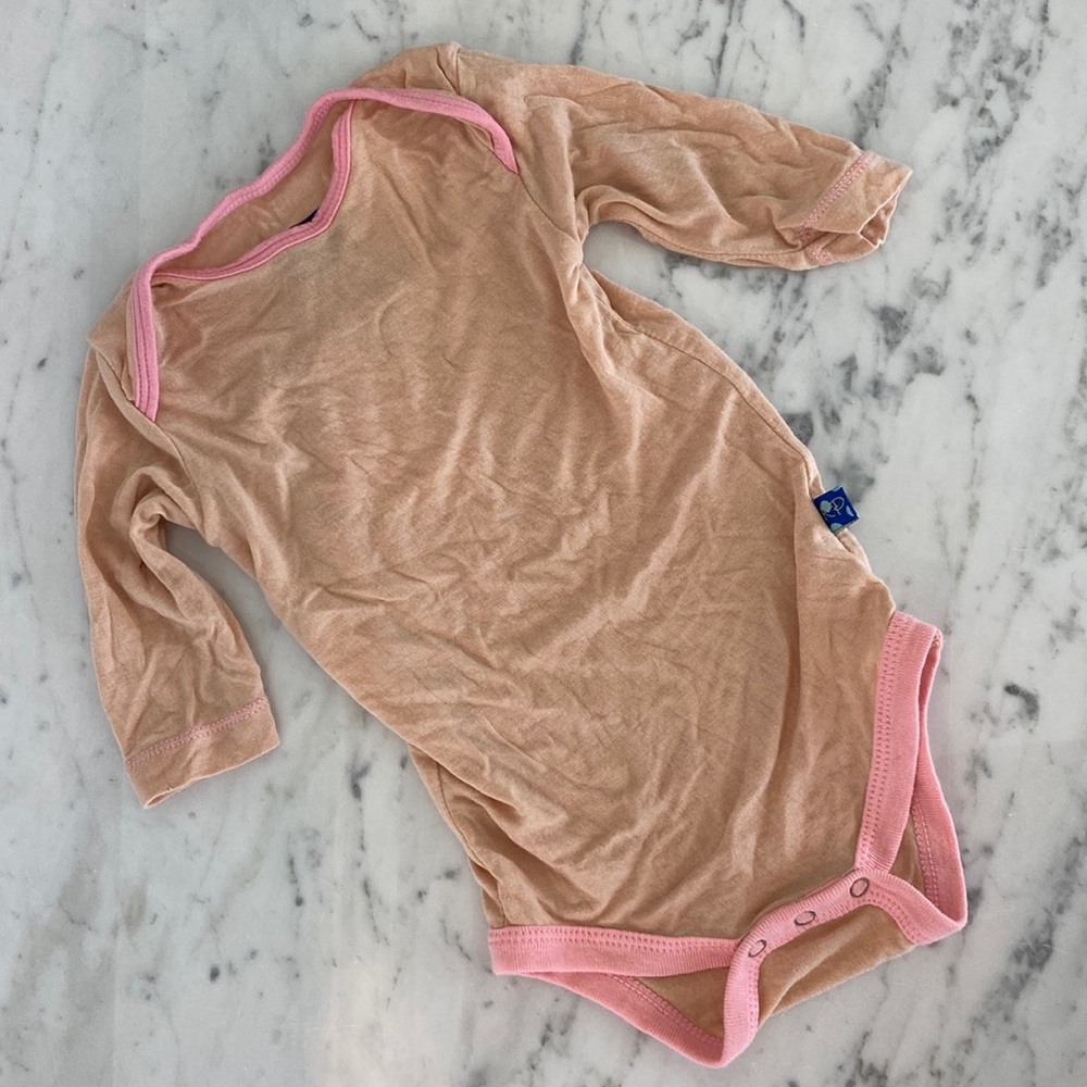 Nude with pink trim precious baby onesie. Softest and in great condition.